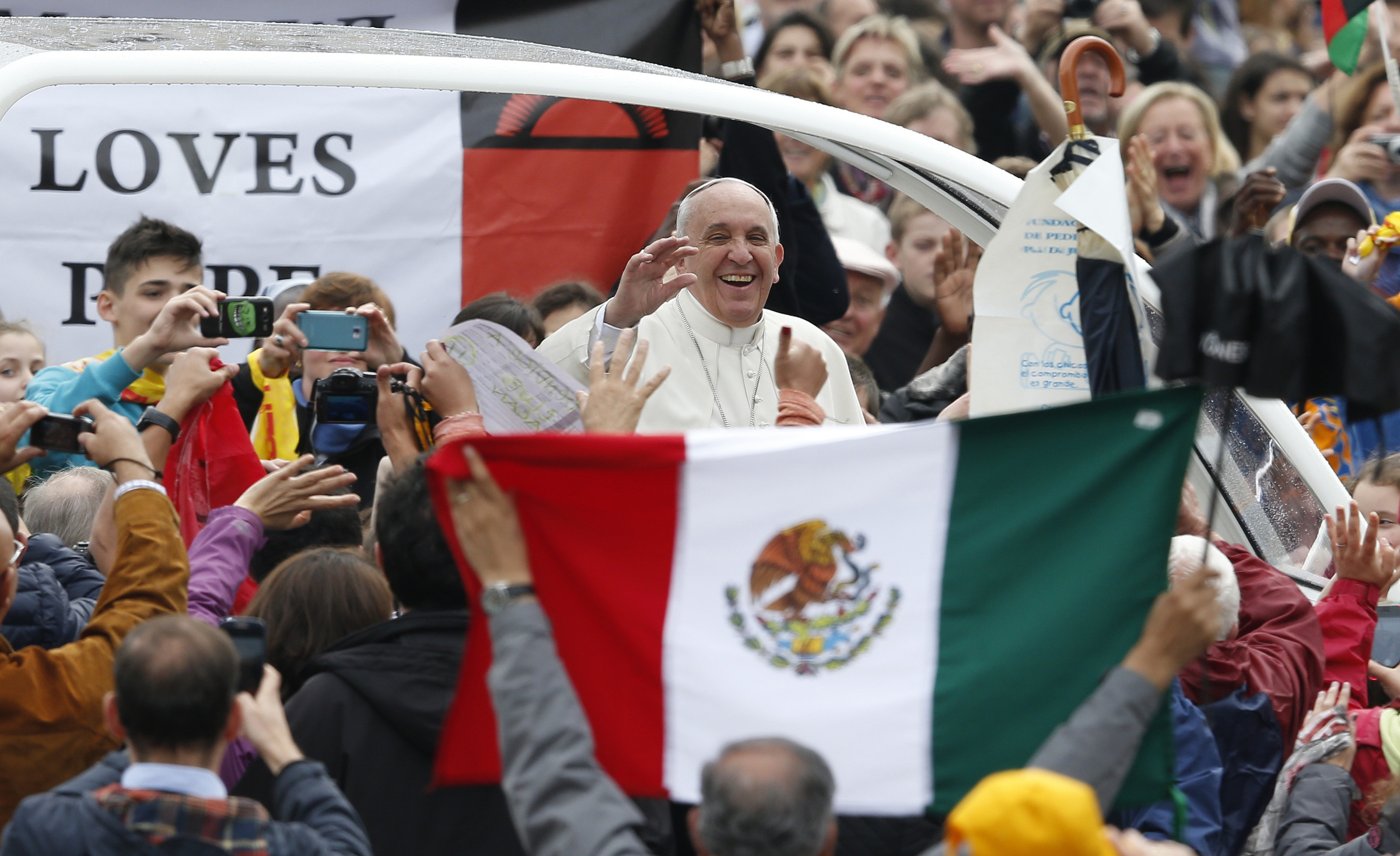 Pope Francis passes Mexico's flag as he arrives to lead general audience in St. Peter's Square at Vatican