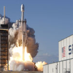 A SpaceX Falcon Heavy rocket, carrying the Arabsat 6A communications satellite, lifts off from the Kennedy Space Center